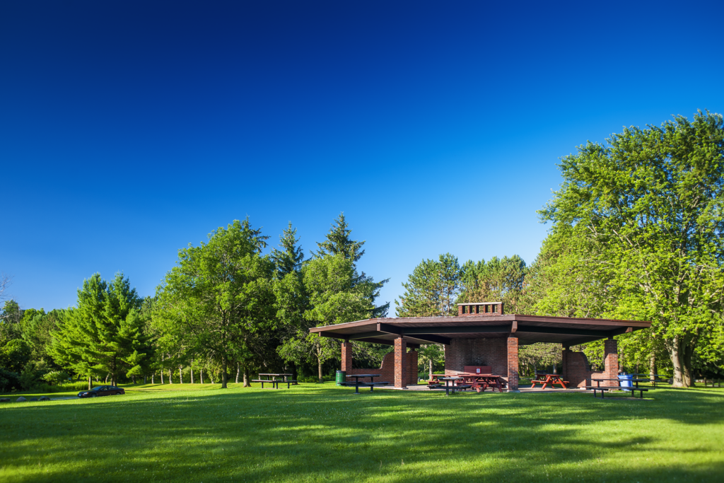 Scanlon Creek South Pavilion welcomes visitors with picnic tables that are neatly arranged, providing a tranquil and inviting spaces for individuals to gather.