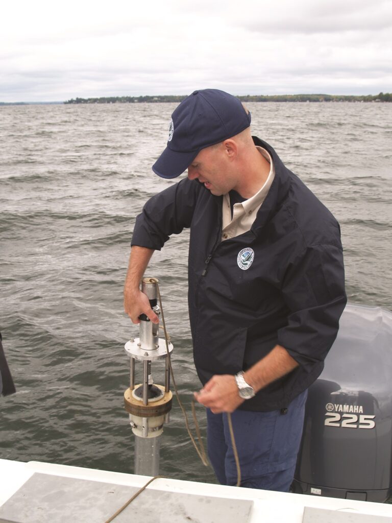 LSRCA's limnologist collecting a water sample in Lake Simcoe.