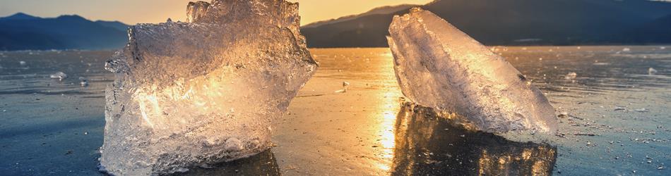 very large beautiful chunk of ice during sunrise in winter