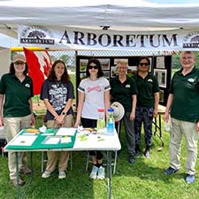 Volunteers from Aurora Arboretum standing in front of a table