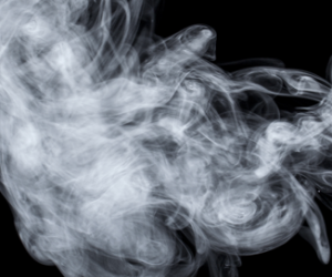 A haze of Phenols smoke disperses on a black background.